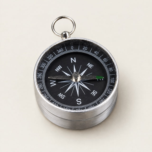 Studio view of Metal Field Compass on a warm neutral background