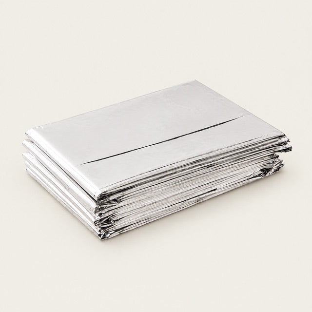 Studio view of Mylar Blanket 4-Pack on a warm neutral background